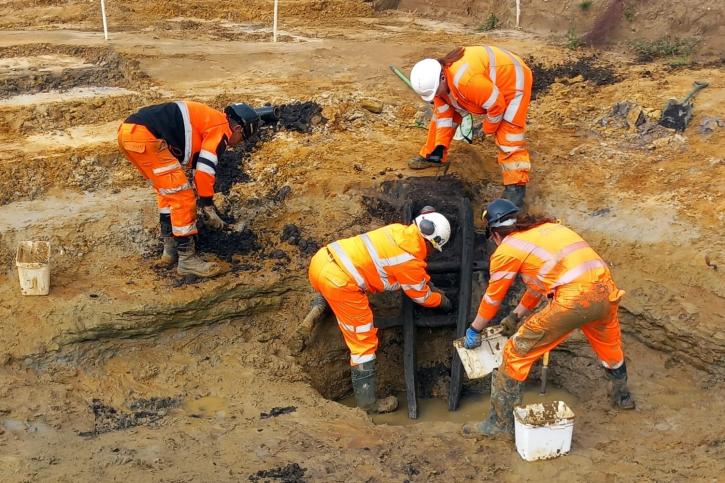 SZC An Iron Age ladder placed in a well being carefully exposed and recovered by the OCA team Oxford Cotswold Archaeology 3x2